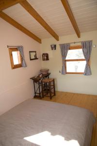ein Schlafzimmer mit einem Bett und einem Schreibtisch in einem Zimmer in der Unterkunft Kouklospito Agios Polykarpos in Raches
