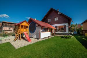 a house with a playground in the yard at Chata Radiva in Žiar