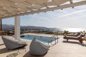 a house with a swimming pool and a patio at Mythology Villas & Suites in Stelida