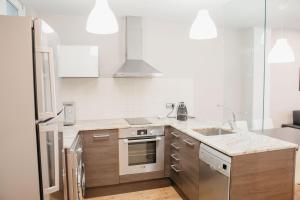 a kitchen with a sink and a stove top oven at Cal Miquel in Alpens
