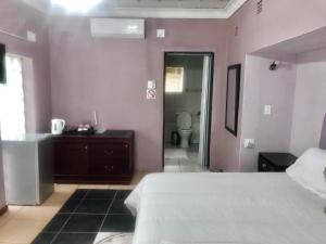 Un ou plusieurs lits dans un hébergement de l'établissement Ankuweni Guest house