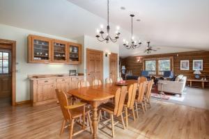 a kitchen and dining room with a wooden table and chairs at Bishop's Retreat in Estes Park