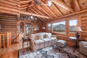 a living room with a couch in a log cabin at Bishop's Retreat in Estes Park