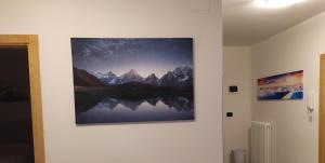 a painting hanging on a wall in a room at Appartamento DIAMANTE in Passo del Tonale