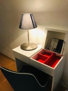 a lamp sitting on top of a toy box with a mirror at The Barts City Center - Self Check-in in Vienna