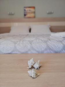 a piece of paper sitting on a table next to a bed at Aloni Studios and Apartments in Lassi
