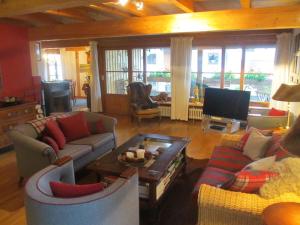 a living room with couches and a flat screen tv at Chalet Montfort in Sonthofen