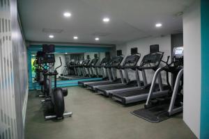 a gym with a row of treadmills and machines at Holiday Inn Tuxpan - Convention Center, an IHG Hotel in Tuxpan de Rodríguez Cano
