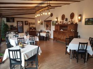 a dining room with white tables and chairs at Casa Irinella in Satu Mare