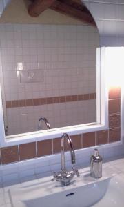 a bathroom sink with a mirror above it at Mansarda Vista lago a Campodolcino in Campodolcino