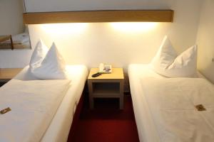 Postel nebo postele na pokoji v ubytování Hotel Scholz
