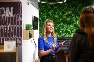 a woman standing in a room talking to another woman at ibis budget Swindon in Swindon