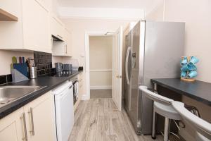 a kitchen with white cabinets and a refrigerator at Salt Lane Apartments in Salisbury