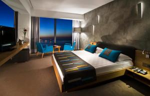 a bedroom with a bed with a view of the ocean at Ilayda Avantgarde Hotel in Kuşadası