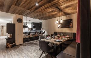 a dining room with a table and a fireplace at Alpenchalet Montafon in Gaschurn