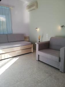 a living room with two couches and a couch at Aloni Studios and Apartments in Lassi