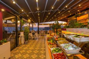 a market with fruits and vegetables on display in a restaurant at Alpek Hotel in Istanbul