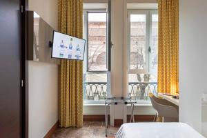 a hotel room with a bed and a window at B&B Hotel Milano Sant'Ambrogio in Milan
