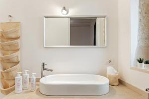 a bathroom with a white sink and a mirror at Nido alla Giudecca con terrazza by Wonderful Italy in Siracusa