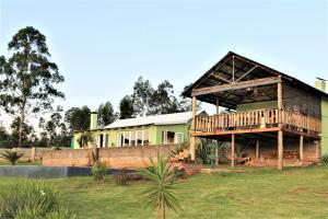 a house with a porch and a deck at Round Here Self-Catering Holiday Home in Sabie