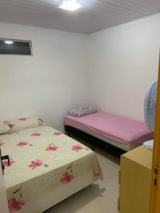 2 camas en una habitación con sábanas rosas en Casa Morro de São Paulo, en Morro de São Paulo