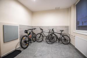 three bikes are lined up against a wall in a room at City Hotel B&B in Banská Bystrica