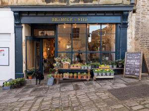 a flower shop with a sign in front of it at Bistro Lotte in Frome