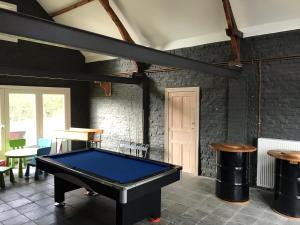 a room with a pool table and two stools at Jachthuis Au Bois Du Gheer in Le Gheer