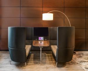 a dining room with two chairs and a table with a laptop at Crowne Plaza Milwaukee South, an IHG Hotel in Milwaukee