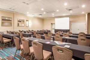 a conference room with tables and chairs and a whiteboard at Crowne Plaza Portland - Lake Oswego, an IHG Hotel in Lake Oswego