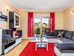 uma sala de estar com um sofá e uma televisão em Rona apartments Smokva em Rijeka