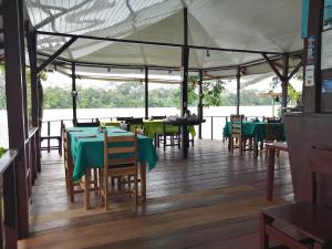 a dining area with tables and chairs in a tent at Chinitas Eco Lodge in Tortuguero