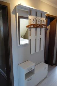 a bathroom with a mirror and a white table at Ferienwohnung Itzgrundblick in Großheirath