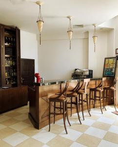 a bar with wooden bar stools in a room at Beach Apartment in Obzor