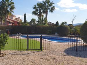 une clôture en face d'une piscine dans l'établissement HL 017 ·HL 017 3 bedroom 2 bathroom, villa high standard, à Fuente Alamo