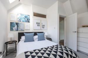 a bedroom with a large bed with blue pillows at Beach View Apartment in Saltburn-by-the-Sea
