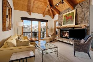 a living room with a couch and a fireplace at 229 Faraway The Ridge #36 condo in Snowmass Village