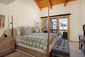 a bedroom with a canopy bed and a balcony at 229 Faraway The Ridge #36 condo in Snowmass Village +26 photos