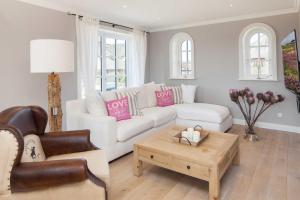 a living room with a white couch and a coffee table at Beachalm in List