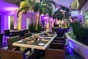 a restaurant with a table and chairs and purple lighting at Crowne Plaza Toluca - Lancaster by IHG in Toluca