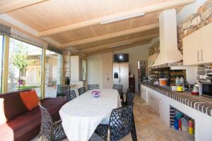 a kitchen and living room with a table and chairs at Acrothea Perdika in Perdika +31 photos