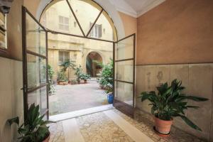 an empty hallway with potted plants in a building at Home Vaticano 50 steps from Museum in Rome