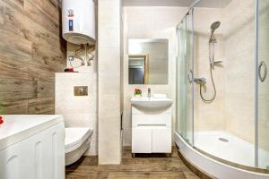 a bathroom with a sink toilet and a shower at Apartments on Klovsky descent 20 in Kyiv