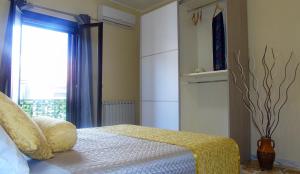 a bedroom with a bed and a large window at Casa Le Maioliche in Giardini Naxos