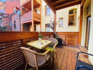 a wooden deck with a table and chairs on it at Linden-Charm Apartments in Hannover