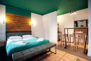 a bedroom with a large bed with a green ceiling at Neue Gasse Lviv apartments in Lviv