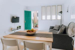 a living room with a table with a bowl of fruit at Central location in a great complex with 300mbps internet in Puerto del Carmen