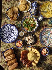 a table topped with plates of food and dips at Riad Dar Senhaji in Fès