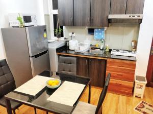 a kitchen with a table with a bowl of fruit on it at SummerHome Metro in Hulhumale