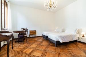 a bedroom with a bed and a desk and a piano at Del Remer Apartment - 5mins from San Marco sq in Venice